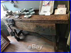 Vintage antique reconditioned carpenter industrial work bench with working vice