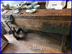 Vintage antique reconditioned carpenter industrial work bench with working vice